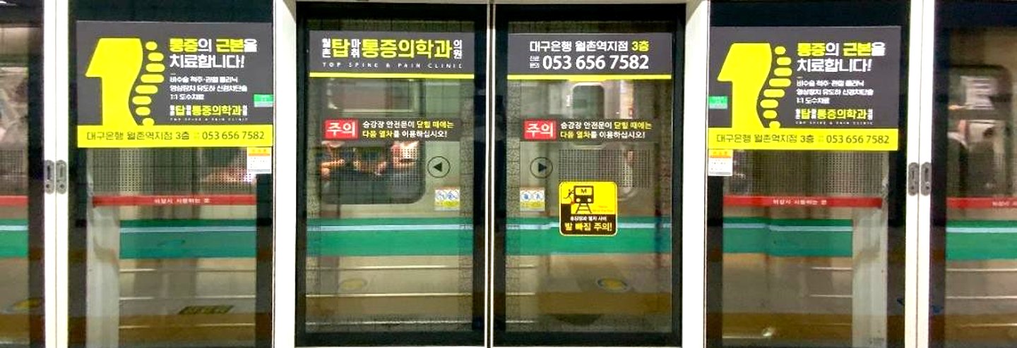 지하철 승강장 스크린도어에 통증의학과 광고가 붙어 있는 모습