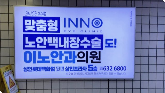 지하철 역사 벽면에 걸린 안과의원 조명 광고판